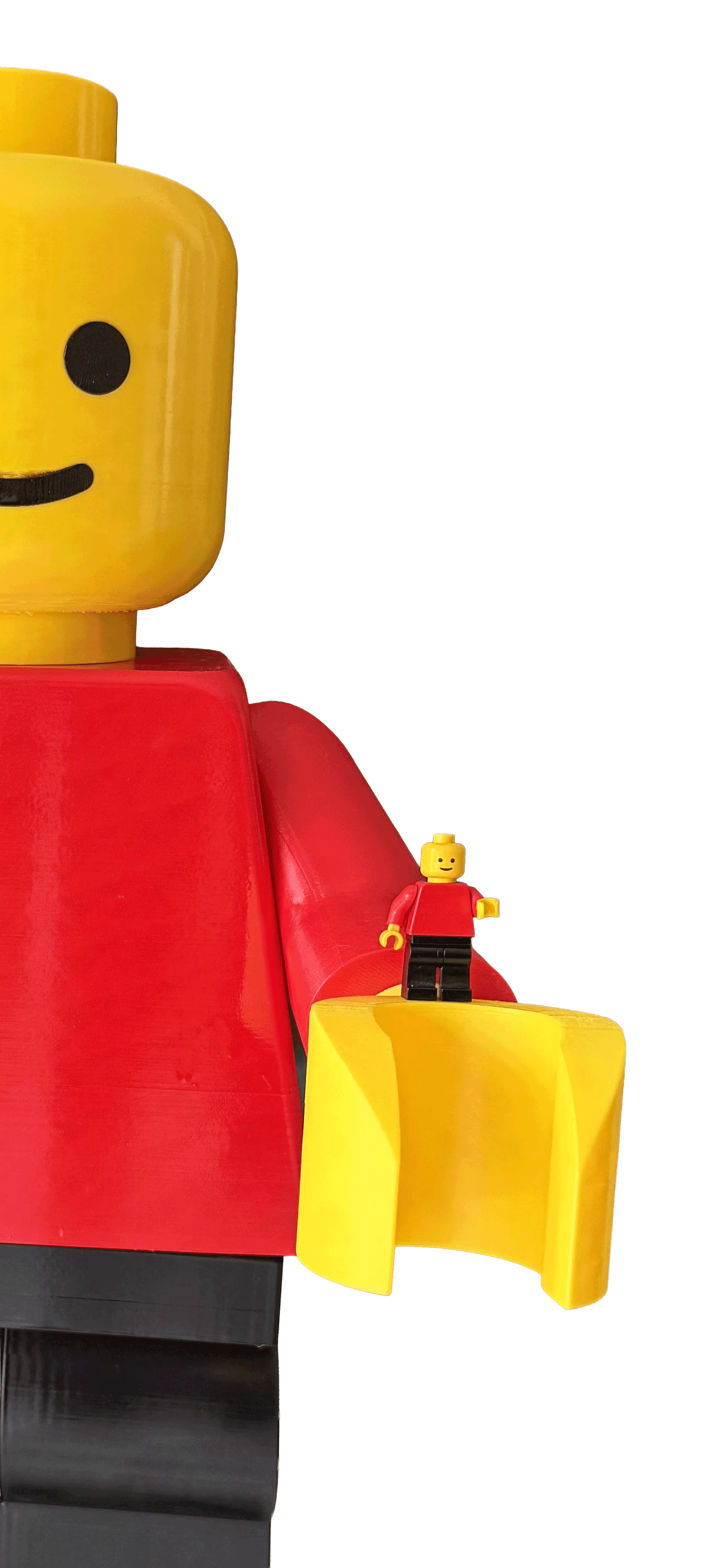 A standard minifigure standing in the open hand of the BRED edition Mega Figure, ten times its size