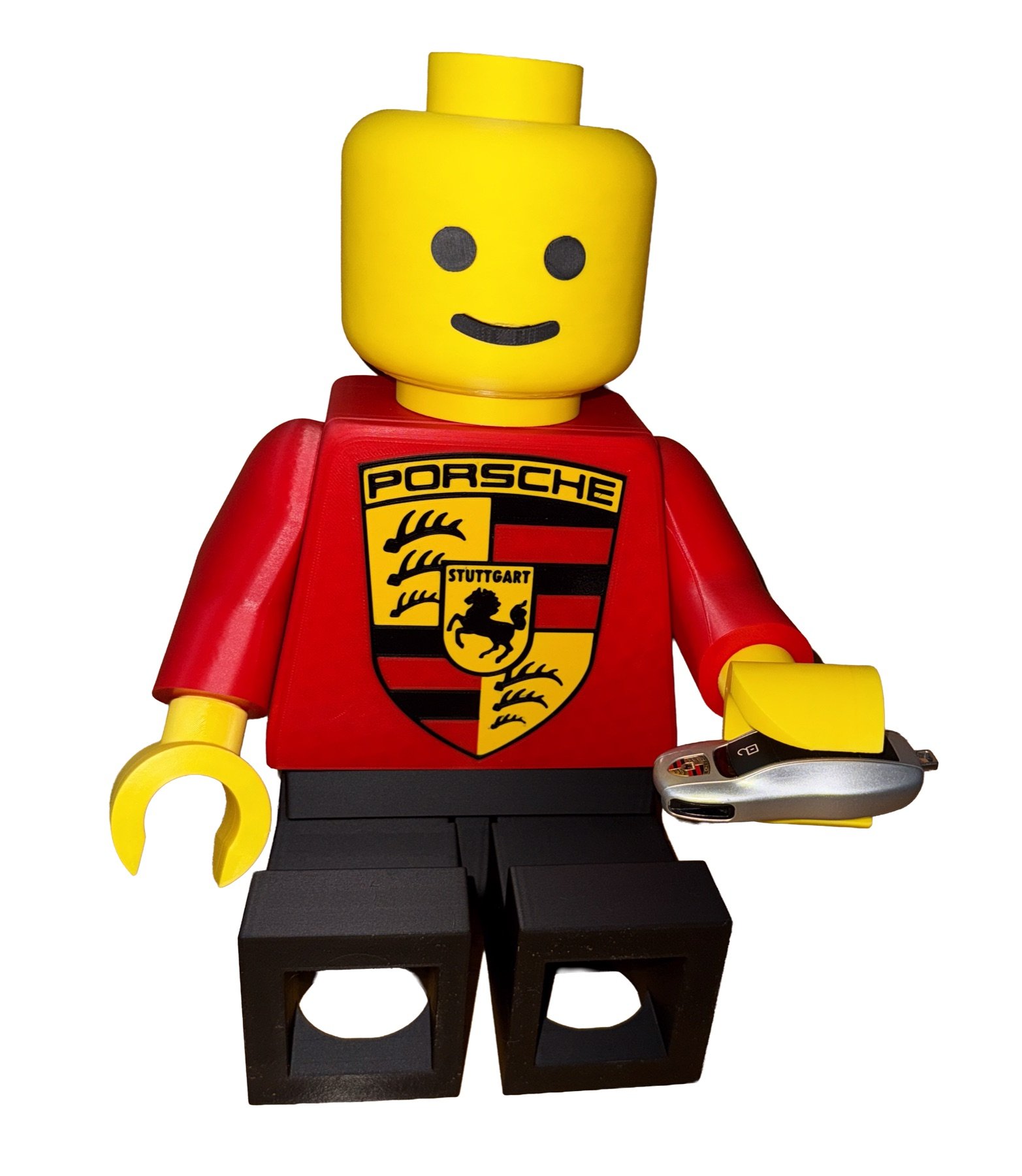 Mega Figure with a racing crest torso and matte black legs holding a car key in an open hand