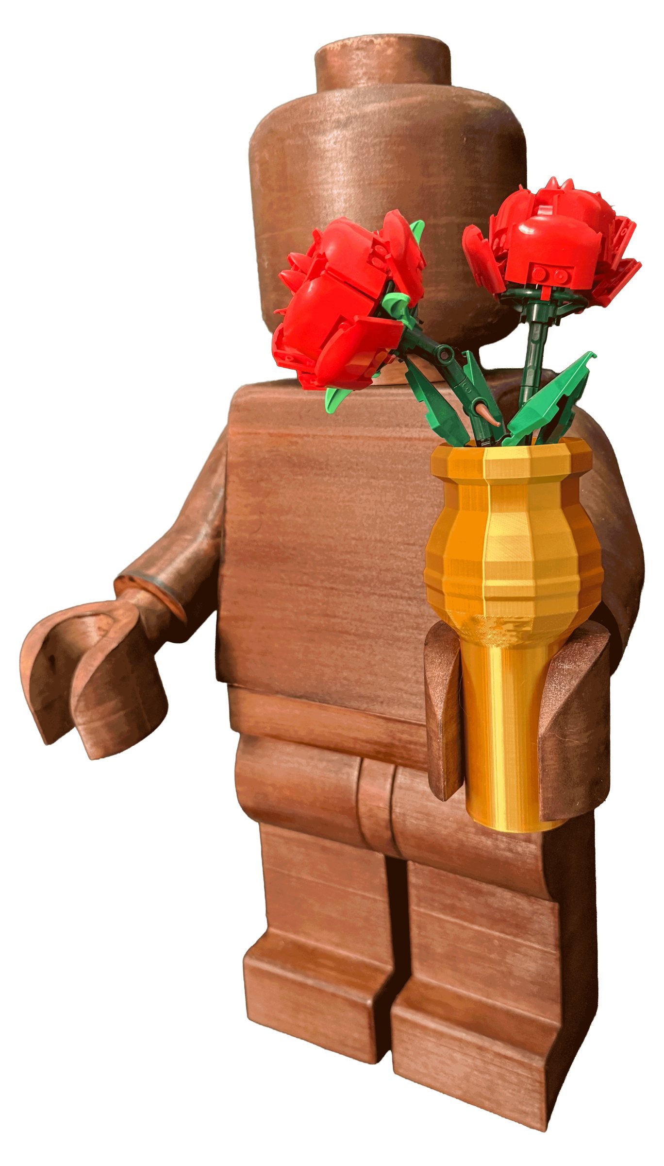 The Wood Edition holding a gold 3D-printed vase with two red LEGO roses in it